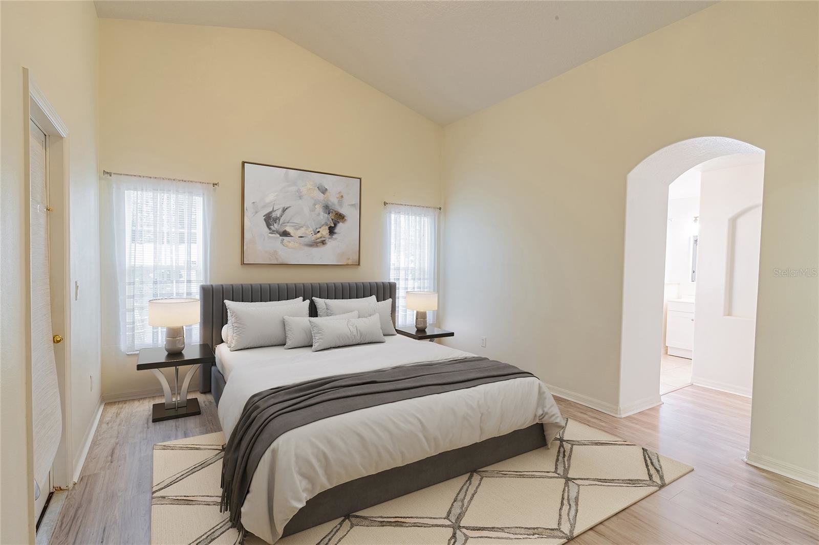 bedroom with two windows next to bed in center of wall